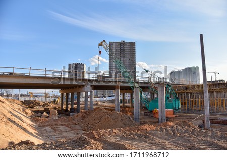 Roundabout and traffic bridge construction. Construction highway ramps and bridgeworks. Crane for formwork on bridge project works. Road work on traffic highway, road intersection junction and freeway Stock foto © 