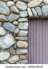 Rounded Fieldstone Wall And Bead Board Door