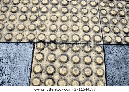 Rounded guiding blocks or warning tactilr blocks near zebra cross really help blind people across safely.