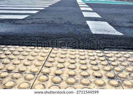 Rounded guiding blocks or warning tactilr blocks near zebra cross really help blind people across safely.