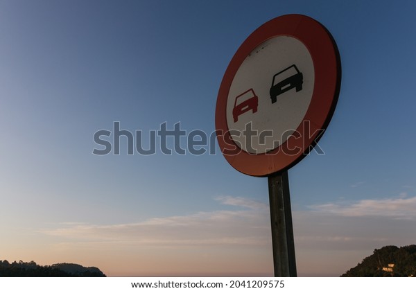 Rounded traffic\
sign in a view from below. Traffic sign in the sunset or sunshine.\
Related to road, traffic or traffic jams. Also related to means of\
transport and\
transportation