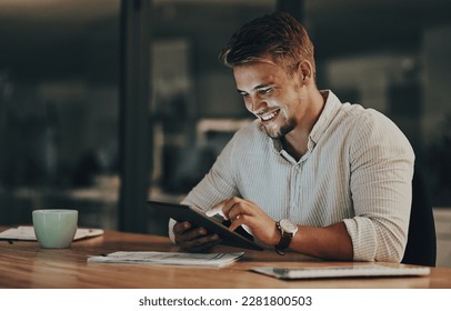 Rounding off another deadline. a young businessman using a digital tablet in an office at night. - Powered by Shutterstock