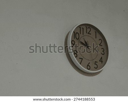 Rounds clock at white wall