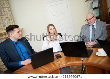 Roundtable meeting of business partners  Business people use laptops and tablets 