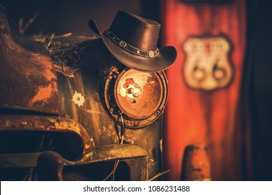 Route 66 Cowboys Concept. Cowboy Hat On The Rusty Classic Car With Broken Headlamp.