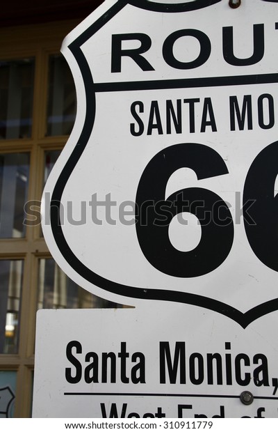 Route 66 sign at the visitor center near\
Santa Monica Pier. Sign marking the western end of the historic\
Route 66 at the Santa Monica visitors\
center