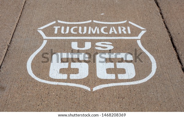 Route 66,\
Tucumcari US, New Mexico. Sign badge on the road, sunny day. Route\
66 the classic historic roadtrip in\
USA