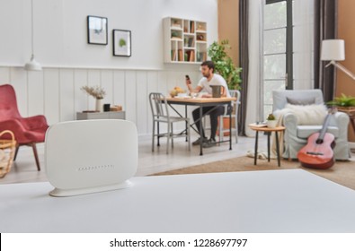 Router Modem Box On The White Table And Home Background With Man Style.