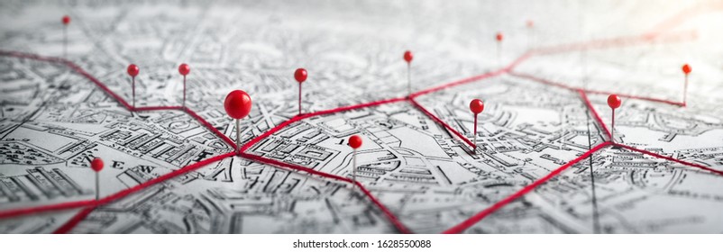 Routes with red pins on a city map. Concept on the  adventure, discovery, navigation, communication, logistics, geography, transport and travel topics.