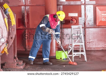 Routine maintenance work on board a cargo vessel at sea.