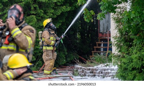 Rouyn-Noranda, Quebec, Canada, June 2022, Firefighters At Work During A House Fire, With Respiratory Protection Equipment