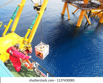 ROV crew deploys inspection class ROV into the sea next to wellhead platform. - Shutterstock ID 1137430085