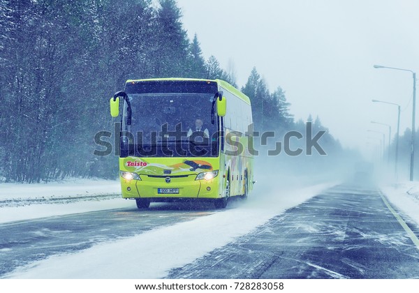 Rovaniemi, Finland - March 1,\
2017: Passenger bus in the road in Rovaniemi, winter Lapland,\
Finland
