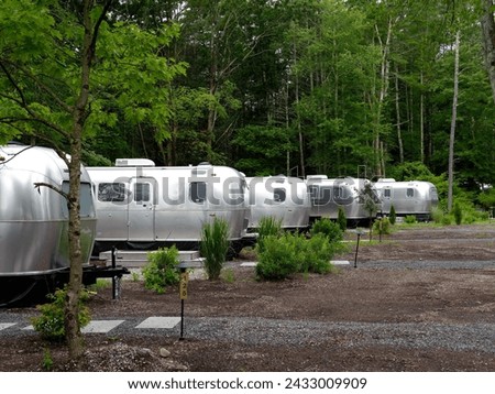 Row of airstream like RV sitting in Campgrounds 