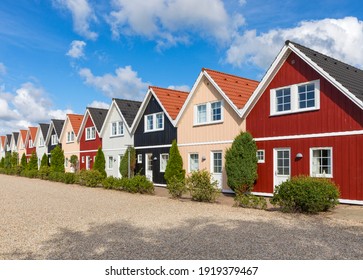 Row Of Almost Identical Wooden Holiday Cottages In Denmark