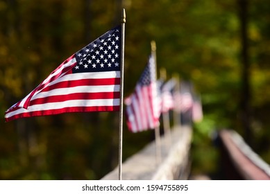 Row of American Flags Along a Bridge