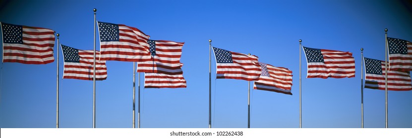 Row of American flags blowing in wind