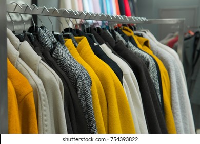 Row Of Autumn Coats Hanging On Rack, Shopping. Cloth Shop, Clothing Store, Female Collection In Fashion Boutique