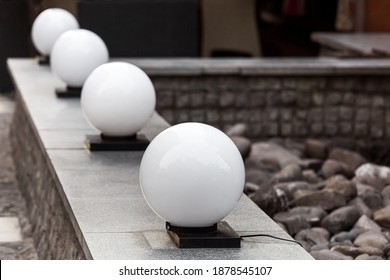 row balls street lantern on granite stone parapet on backyard terrace, lighting object closeup, nobody. - Shutterstock ID 1878545107