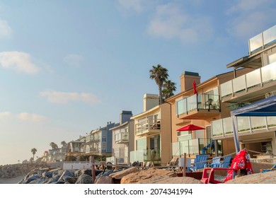 Row Of Beach House Buildings With Lounge Chairs Outside At Oceanside, California