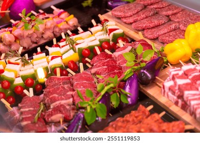 Row beef burger cutlets and lamb meat for grilled raw meat products seasoned with mixed peppers and rosemery on skewers. Diverse raw meat products for sale. - Powered by Shutterstock