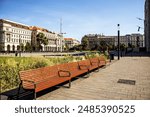 
A row of benches next to the Hungarian Parliament building.