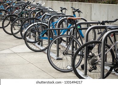 Row of bicycles locked to a bike rack, in a transportation background with space for text on the left - Powered by Shutterstock