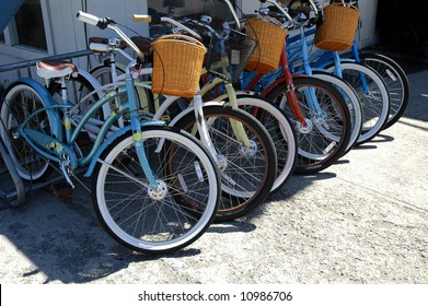 Row Of Bikes With Baskets In A Bike Rack In A City