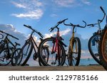 The row of bikes on the beach wit blue cloudy sky background