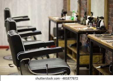 Row Of Black Leather Chairs In Modern Barber Shop Interior. Horizontal Indoors Shot