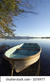 Row Boat On The Lake With Mountains In The Background