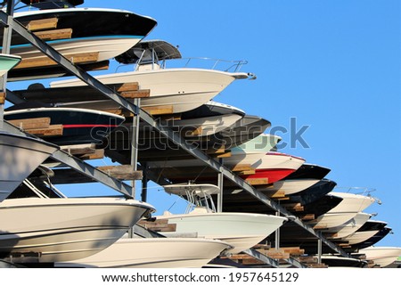 Row of boats sticking out of a boat storage rack in a marina. Maritime storage boat yard