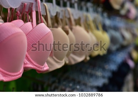 Row of bras in underwear shop blurred background : Self confidence concept.