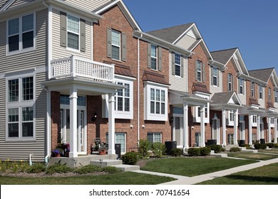 Row of brick townhouses with covered entries