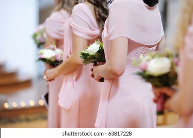 Row of bridesmaids with bouquets at wedding ceremony - Powered by Shutterstock