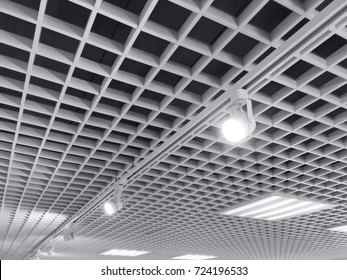 row of bright halogen spotlights on exhibition ceiling grid