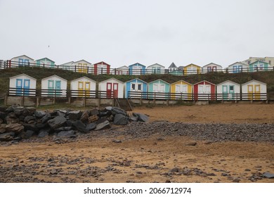 Row of brightly colored beach huts - Powered by Shutterstock