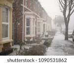 Row of British Edwardian semi-detached houses in a light snow storm