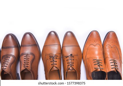 Row Of Brown Three Pair Leather Elegant Brown Shoes On White Background
