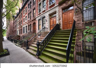 eine Reihe von braunen Gebäuden und Geschäften in einem symbolträchtigen Viertel von Manhattan, New York City.