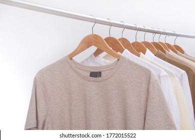 Row Of Business Formal Suit And Polo Shirt And White Long Sleeved Shirt On Hanger
