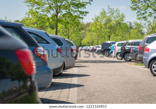 row of cars\
in car parking lot, outdoor\
parking