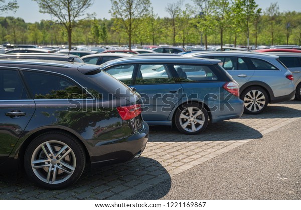 row of cars\
in car parking lot, outdoor\
parking