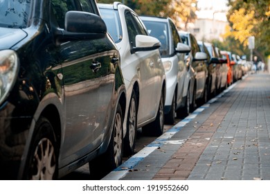 Row Of Cars Parked Near The Sidewalk