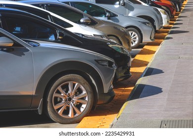 Row of cars parked neatly in Parking lot area on the Street, perspective side view with copy space