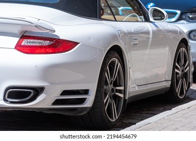 Row Of Cars Parked On The Side Of The Street, White Sports Car In The Foreground, Closeup Of Details