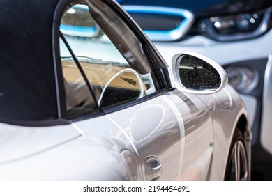 Row Of Cars Parked On The Side Of The Street, White Sports Car In The Foreground, Closeup Of Details