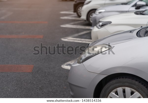 row of cars parked in outdoor parking lot, out door\
parking with lot of cars
