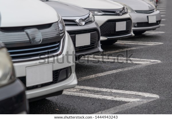 row of cars parked in outdoor parking lot, out door
parking with lot of cars