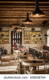 Row Of Ceiling Retro Lamps And Seats In Restaurant Interior